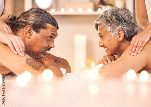 Mature couple, romantic massage at spa in candle light and wellness, relax and smile together. Holistic health therapy, zen and calm man with woman in profile on table in luxury salon in retirement.