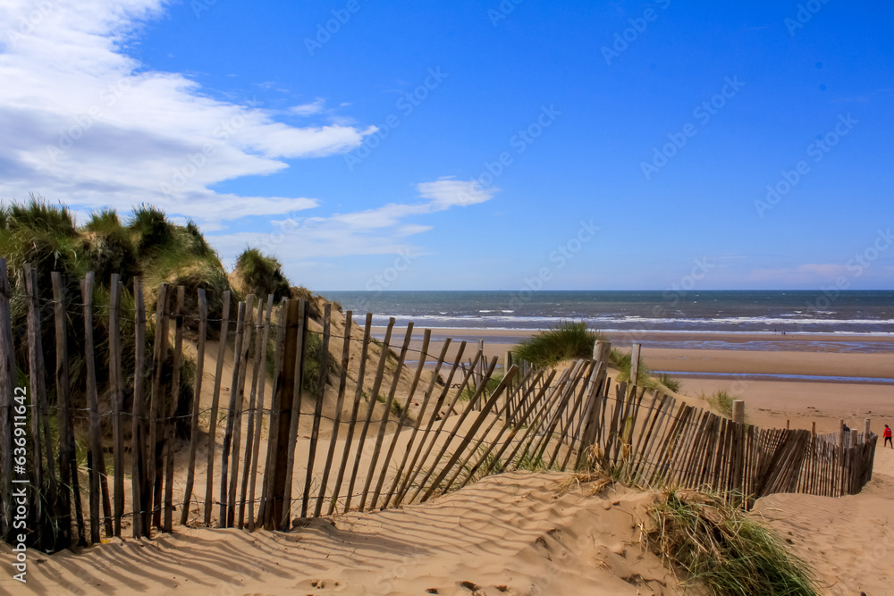 The view of the Formby Beach (Victoria Road Beach) or Formby Dunes in Liverpool, UK at sunny day. City in Merseyside county of North West England. Including the famous sand dunes. Nature, travel scene