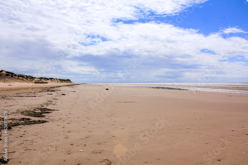 The view of the Formby Beach (Victoria Road Beach) or Formby Dunes in Liverpool, UK at sunny day. City in Merseyside county of North West England. Including the famous sand dunes. Nature, travel scene