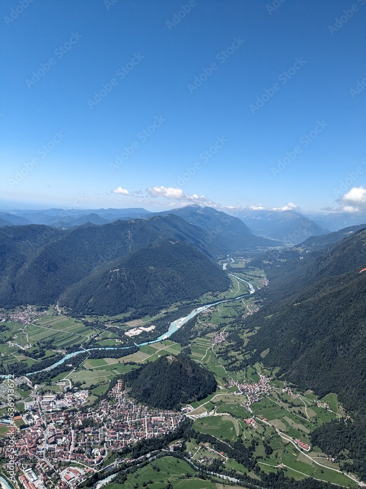 Paragliding beauty of free flying in Julian Alps, big mountains flying at the cloudbase of cumulus clouds,scenic aerial panorama landscape view,Slovenia Stol mountain Europe