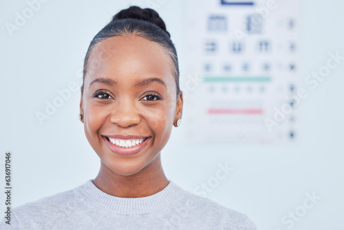 Face, black woman smile and ophthalmology patient in hospital for vision, healthcare or wellness. Portrait, optometrist and happy person in clinic with eye chart for medical professional optician