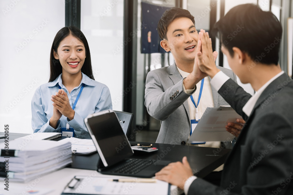 Happy smiling businessman feel happy work complete Teamwork success, success at work in the office concept. Happy smiling businessman feel happy work complete Teamwork success, success at work in the office concept.
