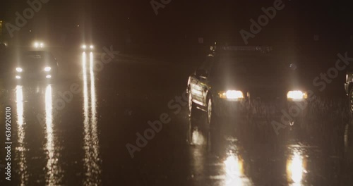 Police car driving at night in the rain