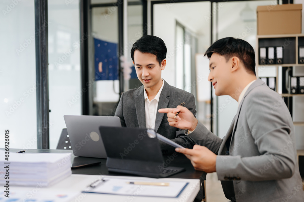 Businesswomen work and discuss their business plans. A Human employee explains and shows her colleague the results paper Businesswomen work and discuss their business plans. A Human employee explains and shows her colleague the results paper