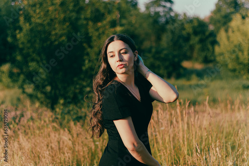 girl with long hair.woman's mental health.calm peaceful dreamy girl.woman dreams and thinks.feeling of relaxation.self-confidence. Sad woman.cheerful woman outdoors.relaxed girl. walking in the meadow