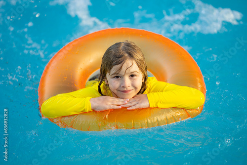 Summertime fun. Little kid swimming in pool. Kid in swimming pool. Kid relax swim on inflatable ring. Summer vacation concept. © Volodymyr