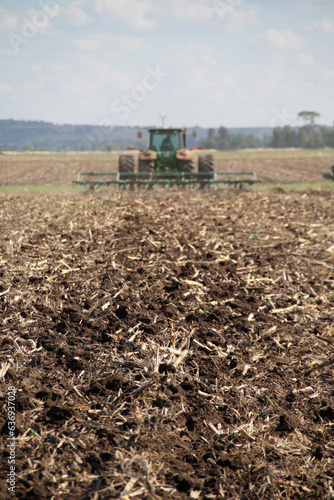 Agricullture  ttractors plowing  in a big field after rain  soil preparation for corn planting in the Northwest of South Africa. 