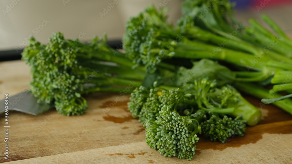 Fresh Broccolini vegetables on a cutting board. Fresh Broccolini vegetables on a cutting board.