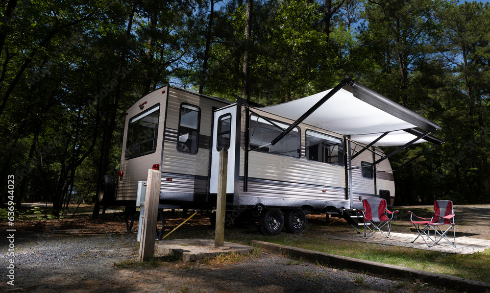 Awnings out on an RV at a campsite Awnings out on an RV at a campsite