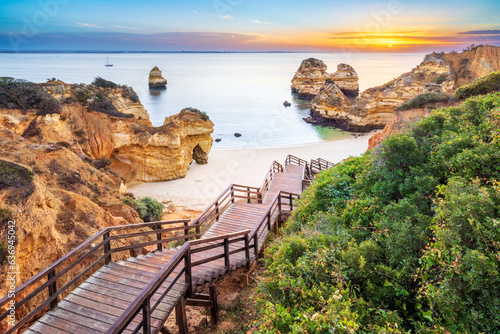 Boardwalk and Stairs to Camilo Beach at Sunrise..Camilo Beach,Praia do Camilo,Natural Cliff Formation and Beach Cove.Lagos,Algarve,Portugal,Europe