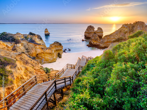 Boardwalk and Stairs to Camilo Beach at Sunrise..Camilo Beach,Praia do Camilo,Natural Cliff Formation and Beach Cove.Lagos,Algarve,Portugal,Europe
