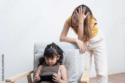 Asian mother feeling worried her daughter game addiction.