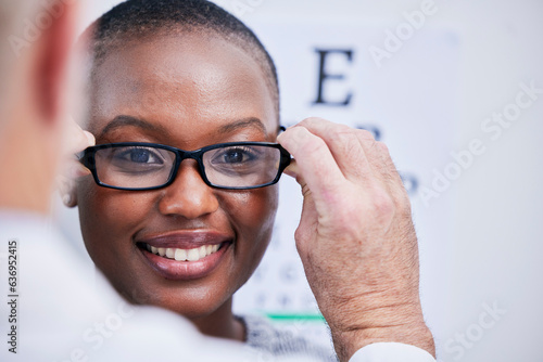 Smile, optometry and a black woman with glasses and a doctor for consultation and eye care. Happy, clinic and an African girl with eyewear from an optometrist for support, test or service for vision