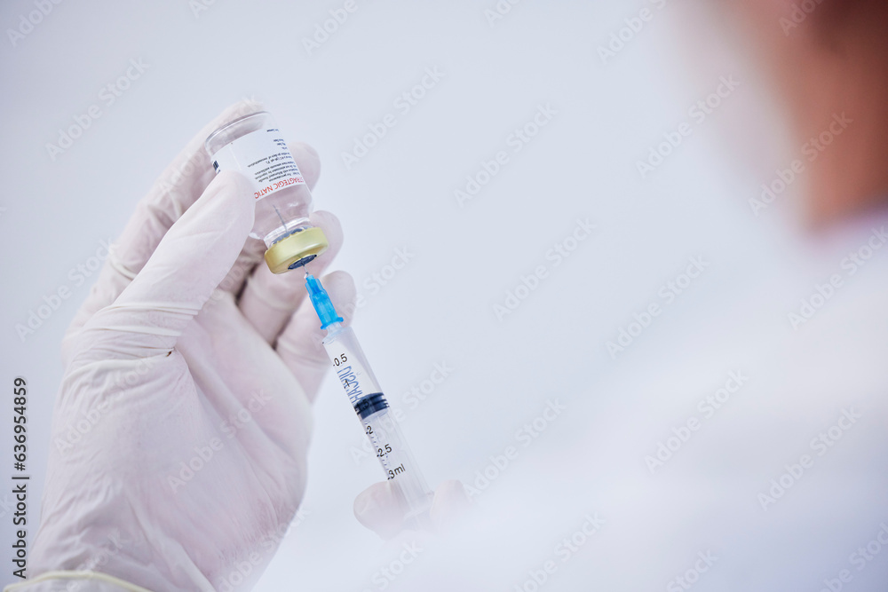 Vaccine bottle, needle and hands of doctor for safety, healthcare and pharmaceutical medicine. Closeup, virus injection and nurse prepare vaccination with vial, medical drugs and immunity in clinic Vaccine bottle, needle and hands of doctor for safety, healthcare and pharmaceutical medicine. Closeup, virus injection and nurse prepare vaccination with vial, medical drugs and immunity in clinic