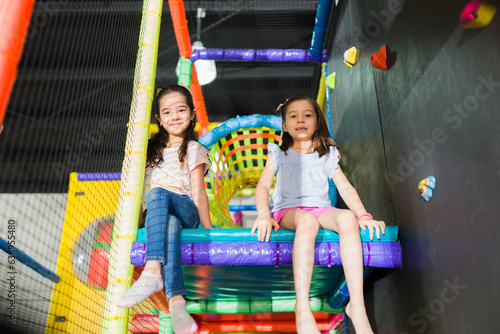 Happy kids smiling playing in the fun indoor playground