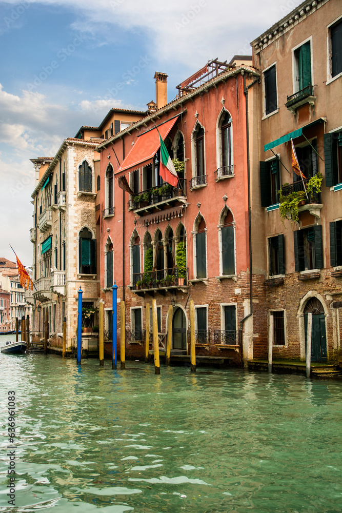 Photo of Venice's iconic waterfront with a picturesque row of buildings reflected in the tranquil waters