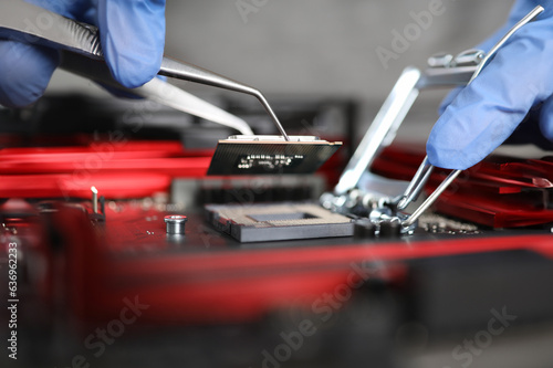 Close-up gloved hands repairing microchip details. Testing microprocessor-based industrial devices. Failure detection diagnostics and device repair. Recovery drive. Microprocessor protection design © H_Ko