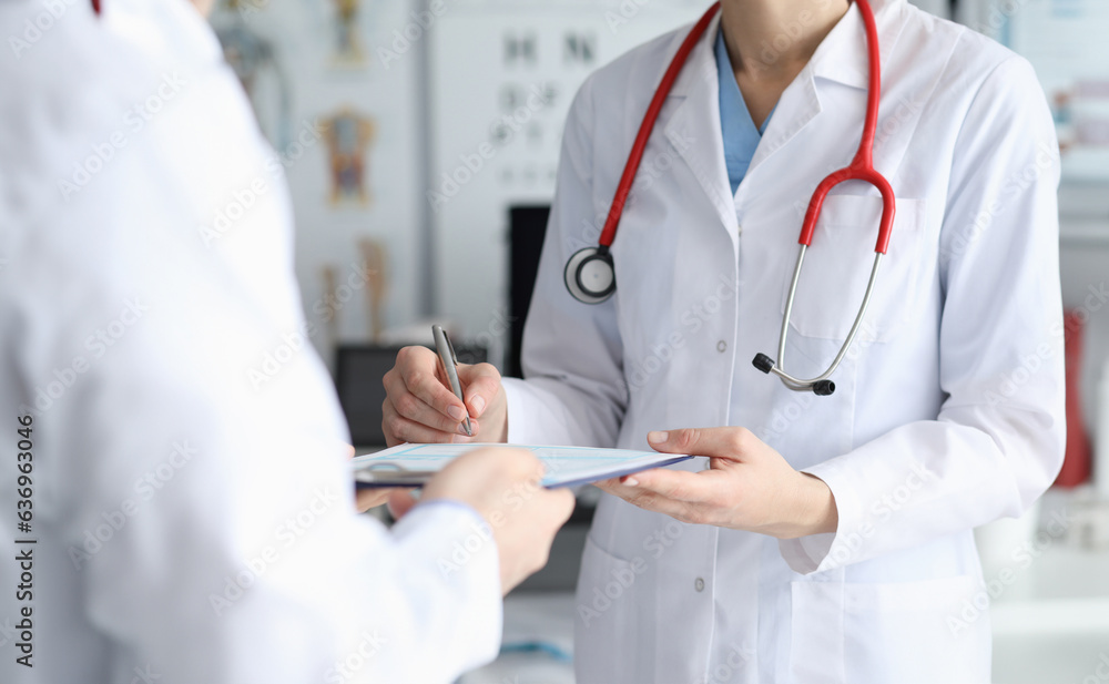 Female doctor signs patient card with diagnosis. Help qualified doctors. Admission department equipped with everything necessary for diagnosis and treatment patients. Drug withdrawal acute conditions Female doctor signs patient card with diagnosis. Help qualified doctors. Admission department equipped with everything necessary for diagnosis and treatment patients. Drug withdrawal acute conditions