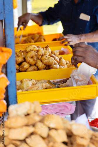 Street food vendor selling fried snacks in Asia photo