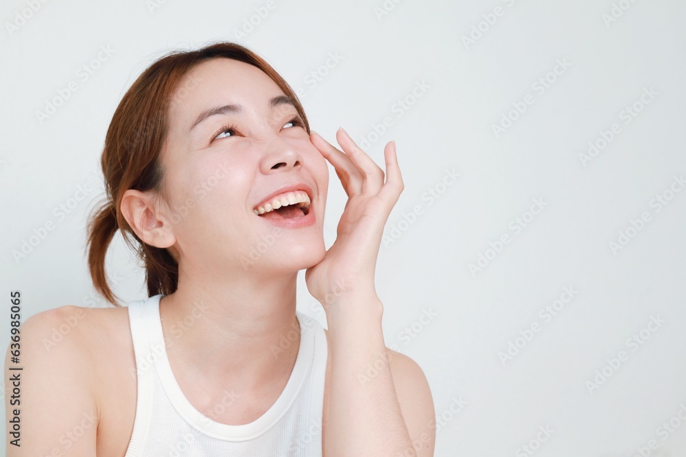 Beautiful Asian woman in natural makeup over isolated background with copy space. Beautiful Asian woman in natural makeup over isolated background with copy space.