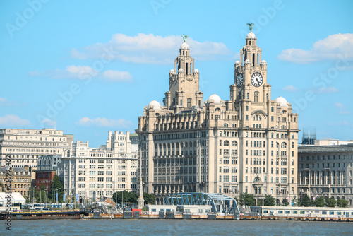 View of the iconic Royal Liver Building in Liverpool from River Mersey, with the Liver Birds, Bella and Bertie crowning the famous piece of architecture, guarding the city