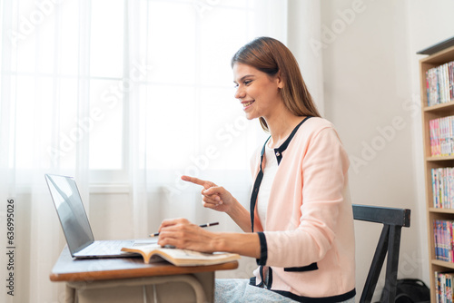 Portraits of beautiful smiling women relax using laptop computer technology while sitting on their desks and using their creativity to work, work from home concept.