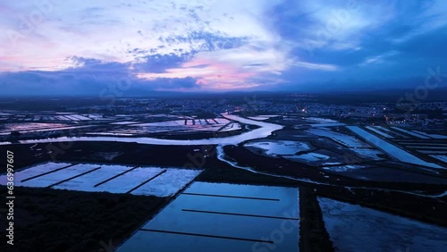 Sunset over salt pans and marsh in Tavira in the district of Faro. Aerial view from a drone. Marshes and salt flats of the Ria Formosa Natural Park. Atlantic Ocean. Algarve. Portugal. Europe