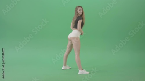 Young woman shaking ass in side view twerking dance over green screen 4K Video Footage