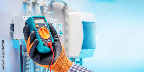 Fotografie electrician work tester measuring voltage in fuse board