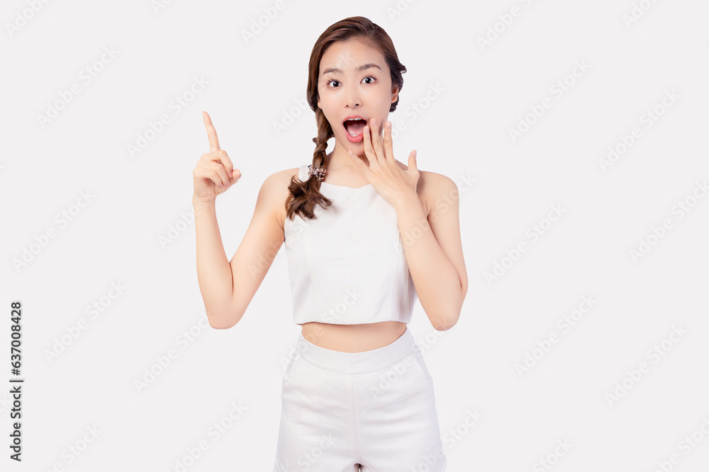Excite young Asian woman pointing up to copy space looking at camera with smile face Smiling Pretty female invite customer to buy your product, use for advertising with isolated on white background Excite young Asian woman pointing up to copy space looking at camera with smile face Smiling Pretty female invite customer to buy your product, use for advertising with isolated on white background