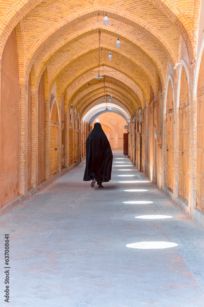 Iranian  lone woman walks in a completely close grand bazaar - Shiraz, iran    