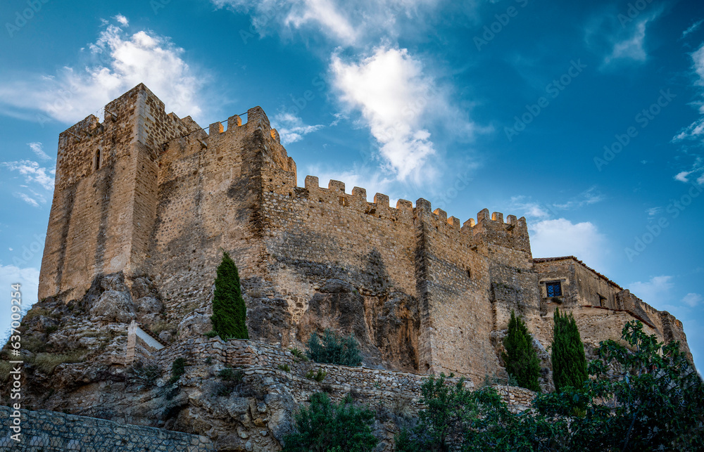 View of the medieval castle on the rock of Yeste, Albacete, Spain, with daylight and sky with clouds
