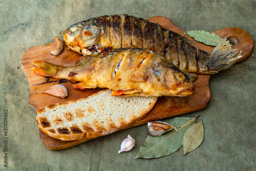 Fried appetizing fish on barbecue, picnic food close-up Fried appetizing fish on barbecue, picnic food close-up