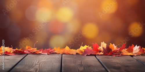 Autumn leaves on wooden table over bokeh background. Autumn  fall concept.