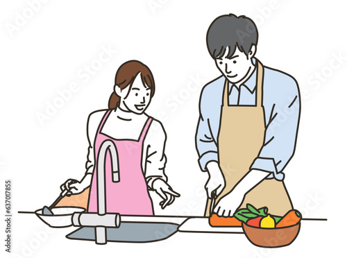 キッチンで料理をする若い男女