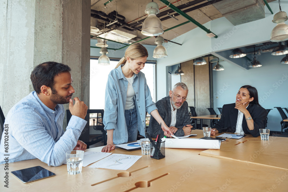 Group of people discussing documents project in the office. Business teamwork situation Group of people discussing documents project in the office. Business teamwork situation