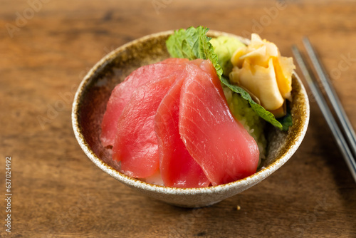 Fresh salmon sashimi don. Raw salmon roe and wasabi. Japanese food on restaurant table. Isolate on wood background