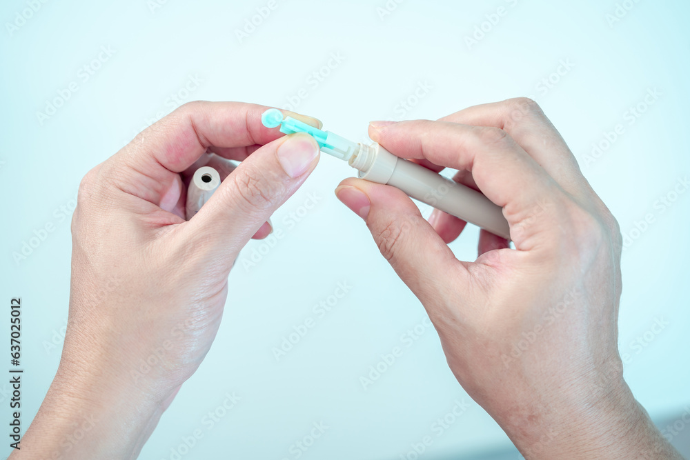 Closeup hand of pregnant woman hold sterile blood lancets prepare for