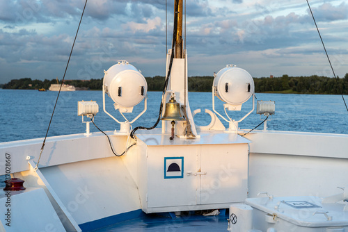 a ship's bell on the bow of a ship going down the river. ship 's rynda photo