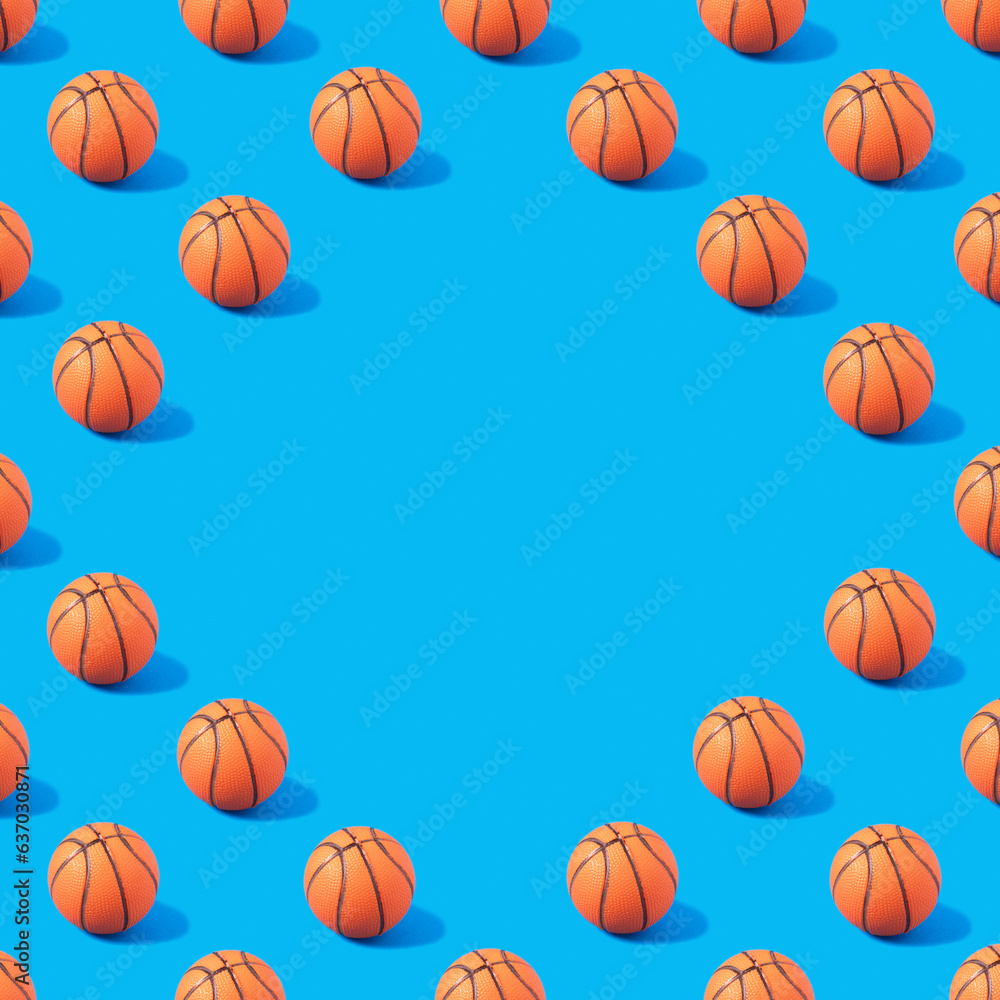 Pattern made of orange basketball on blue background with copy space. Creative sport concept.