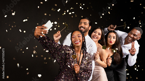 Happy multiracial friends cleebrating New Year together, taking selfie
