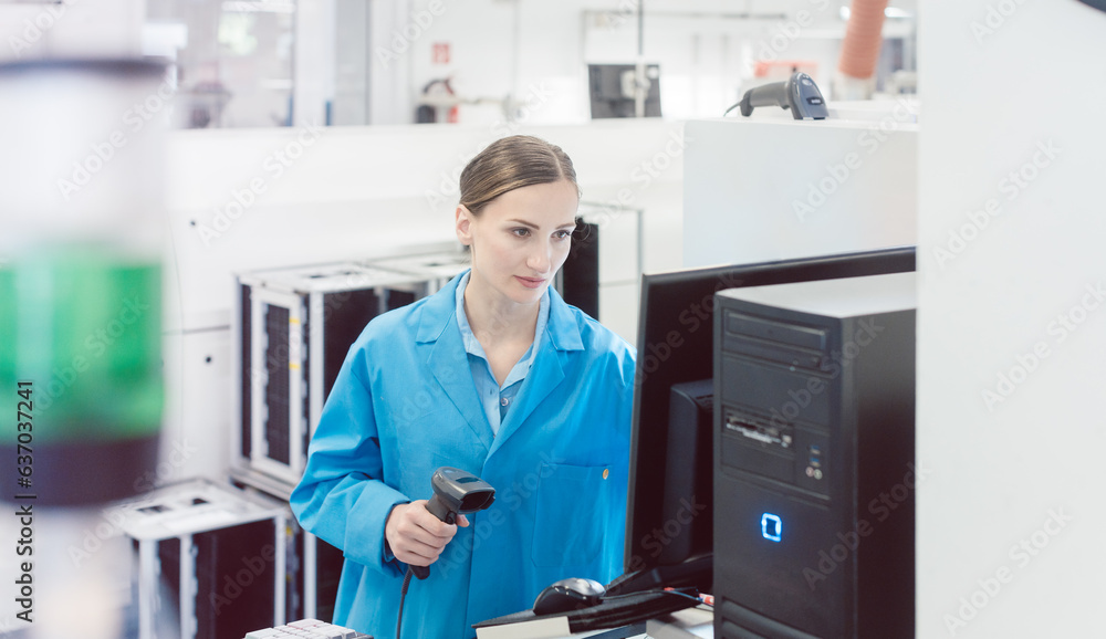 woman electrical engineer working on a placement line in a factory manufacturing electronics. woman electrical engineer working on a placement line in a factory manufacturing electronics.