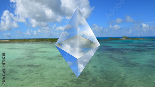 Focus on a transparent octahedron in the foreground, a blurry beach landscape in the background.  photo