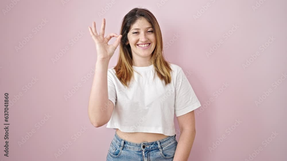 Young blonde woman doing ok gesture smiling over isolated pink background Young blonde woman doing ok gesture smiling over isolated pink background