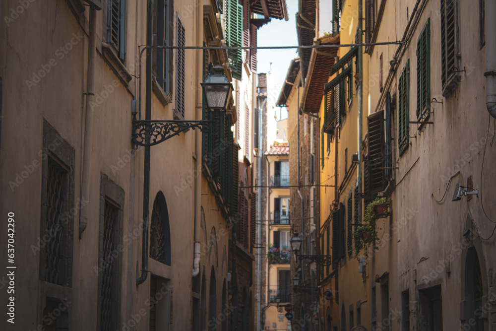 A charming alleyway of Florence, Italy. Lined with traditional shuttered windows and rustic facades, exudes the warmth and historic ambiance of Italy's heartland.