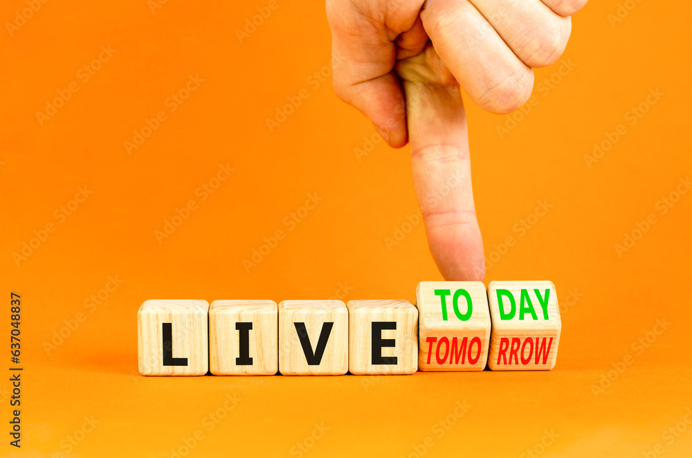 Live today not tomorrow symbol. Businessman turns wooden cubes and ...