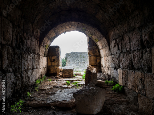 Place where a gladiator enters the amphitheater stage in the ancient city of Perge  Turkey. The walls of the corridor consist of ancient stones of kirpeches  at the exit there is an arch. No people