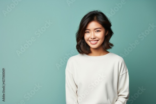Fictional Chinese Model Wearing a Casual and Elegant Outfit and Smiling. Asian Woman Portrait Isolated on a Plain Colored Background. Generative AI.