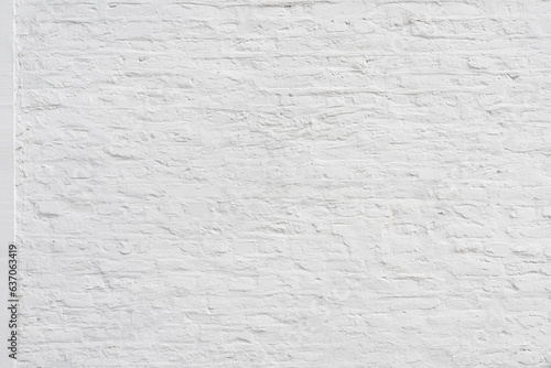 Old plaster wall painted in white with brick pattern as background