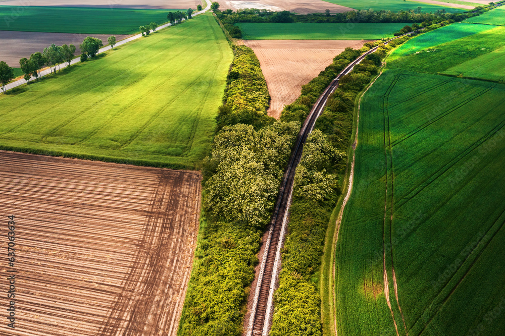 Fotografie Curved railroad track in countryside landscape, drone pov